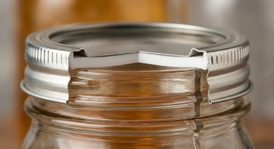 Close-up of glass mason jar lid with PTFE compression gasket seal mechanism